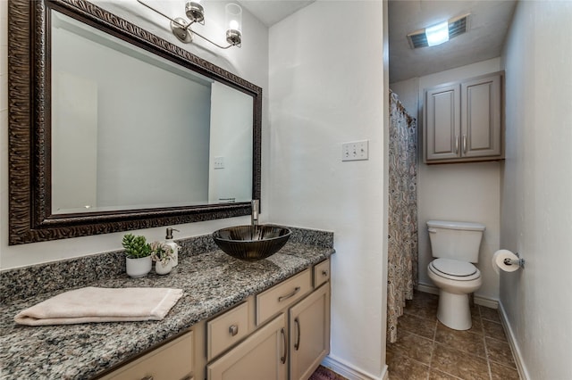 1404 Chicota Dr, Plano, TX 75023 - bathroom with toilet, vanity, tile patterned flooring, and baseboards