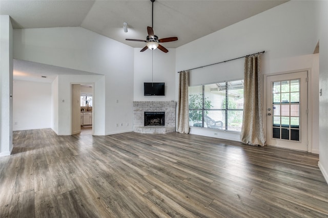 1404 Chicota Dr, Plano, TX 75023 - unfurnished living room with wood finished floors, a ceiling fan, high vaulted ceiling, a brick fireplace, and baseboards