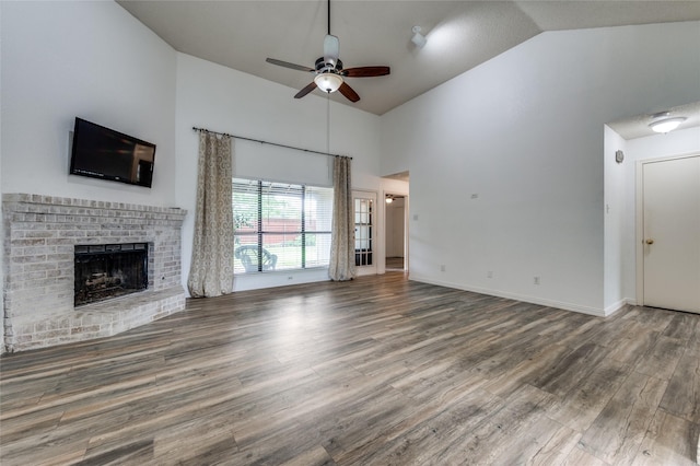 1404 Chicota Dr, Plano, TX 75023 - unfurnished living room featuring a ceiling fan, high vaulted ceiling, a fireplace, and wood finished floors