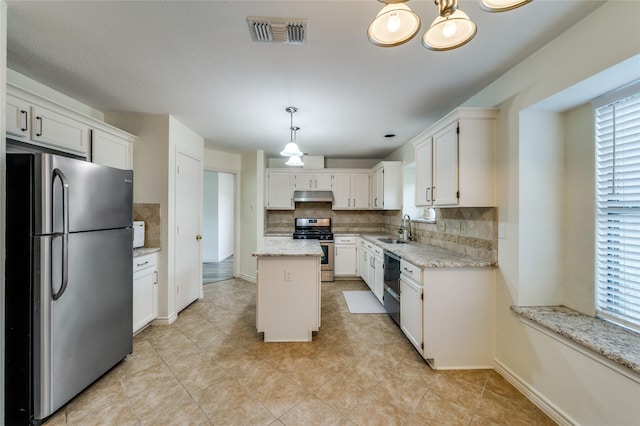 1404 Chicota Dr, Plano, TX 75023 - kitchen featuring appliances with stainless steel finishes, a sink, under cabinet range hood, and decorative backsplash