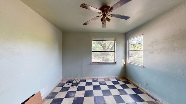 3243 Arizona Ave, Dallas, TX 75216 - empty room featuring tile patterned floors, a ceiling fan, and baseboards