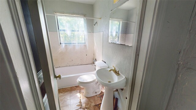 3243 Arizona Ave, Dallas, TX 75216 - full bathroom featuring toilet, a textured wall, washtub / shower combination, and a sink