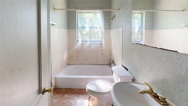 3243 Arizona Ave, Dallas, TX 75216 - full bath with toilet, shower / washtub combination, and a textured wall