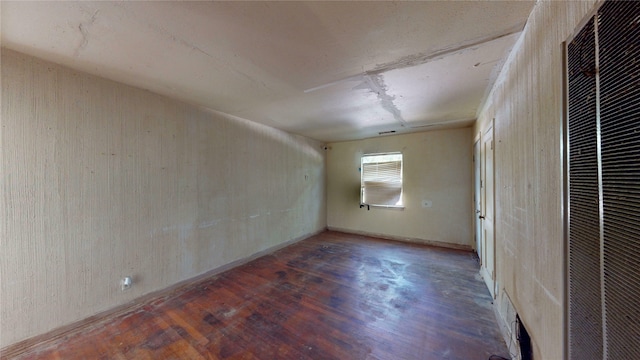 3243 Arizona Ave, Dallas, TX 75216 - spare room with a heating unit and wood finished floors