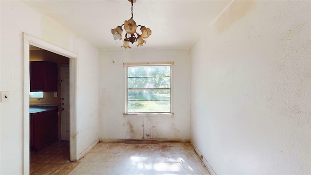 3243 Arizona Ave, Dallas, TX 75216 - unfurnished room with light floors, a chandelier, and baseboards