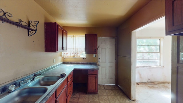 3243 Arizona Ave, Dallas, TX 75216 - kitchen with a sink, light floors, and reddish brown cabinets