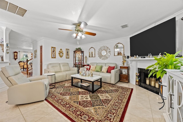 5637 Hunters Bend Ln, Dallas, TX 75249 - living room featuring a ceiling fan, light tile patterned flooring, a fireplace, and crown molding