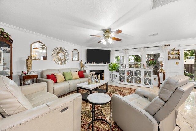 5637 Hunters Bend Ln, Dallas, TX 75249 - tiled living area with a ceiling fan, crown molding, plenty of natural light, and a fireplace