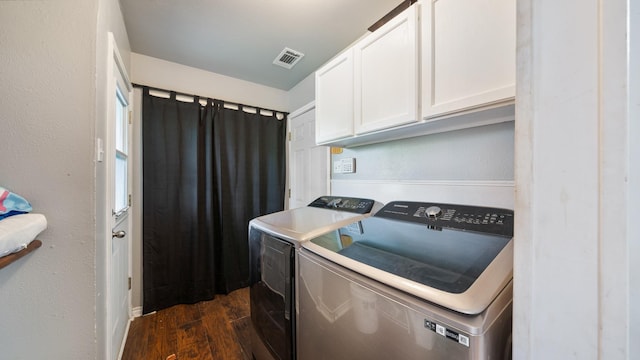 413 E 9th St, Kaufman, TX 75142 - clothes washing area featuring dark wood-style floors, cabinet space, and independent washer and dryer