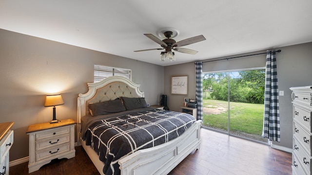 413 E 9th St, Kaufman, TX 75142 - bedroom with access to exterior, dark wood-type flooring, a ceiling fan, and baseboards
