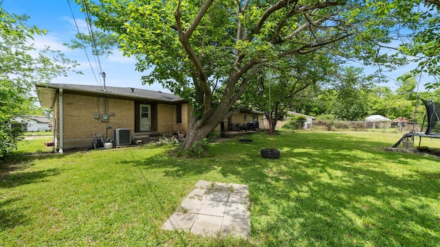 413 E 9th St, Kaufman, TX 75142 - view of yard with a trampoline and central AC