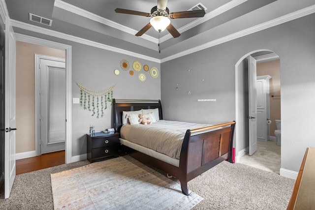 781 Audra Cir, Rhome, TX 76078 - carpeted bedroom with arched walkways, ornamental molding, a tray ceiling, baseboards, and ensuite bathroom