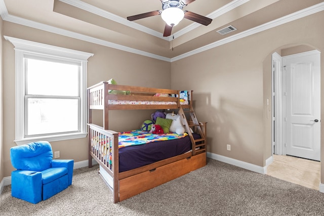 781 Audra Cir, Rhome, TX 76078 - bedroom featuring carpet flooring, arched walkways, baseboards, a tray ceiling, and crown molding