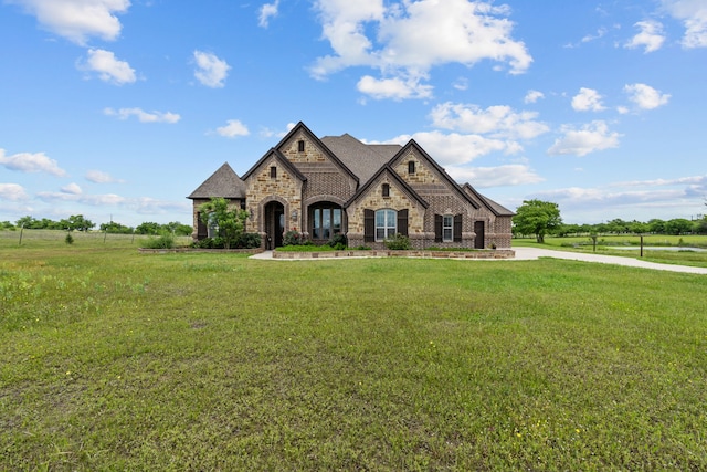 781 Audra Cir, Rhome, TX 76078 - french country style house featuring stone siding, a front yard, and brick siding