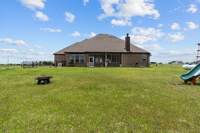 781 Audra Cir, Rhome, TX 76078 - back of property featuring a fire pit, brick siding, a sunroom, and a playground