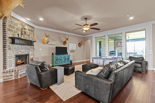 781 Audra Cir, Rhome, TX 76078 - living room featuring wood finished floors, a ceiling fan, crown molding, a stone fireplace, and recessed lighting