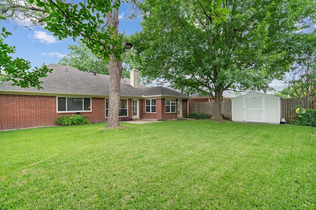 5502 Misty Crest Dr, Arlington, TX 76017 - back of property featuring a storage shed, a chimney, a patio, brick siding, and roof with shingles