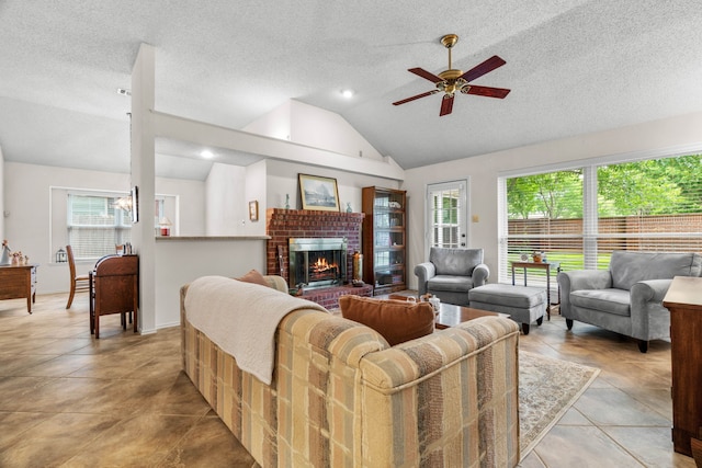 5502 Misty Crest Dr, Arlington, TX 76017 - living room featuring lofted ceiling, ceiling fan, a brick fireplace, and a textured ceiling