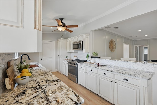4636 Versailles Ln, Plano, TX 75093 - kitchen with stainless steel appliances, ornamental molding, a peninsula, light wood-style flooring, and light stone counters