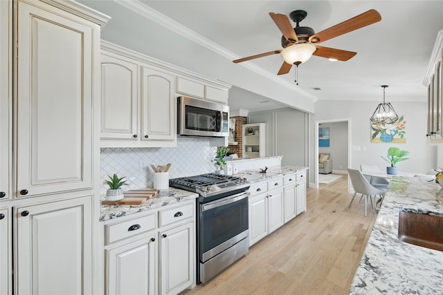 4636 Versailles Ln, Plano, TX 75093 - kitchen with appliances with stainless steel finishes, crown molding, decorative backsplash, light wood-style floors, and ceiling fan