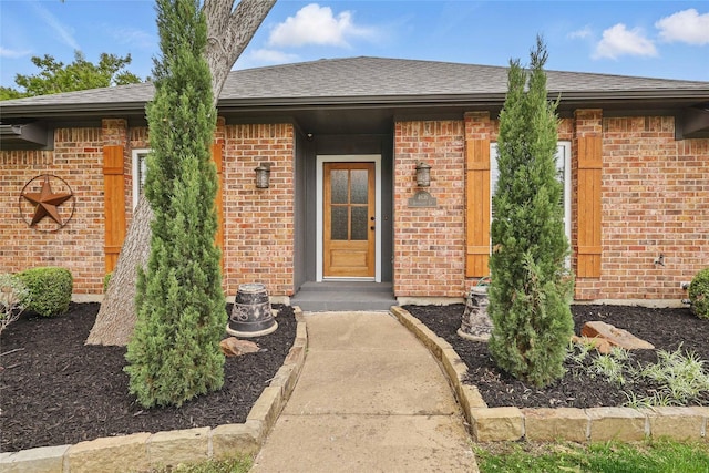 4636 Versailles Ln, Plano, TX 75093 - view of exterior entry featuring brick siding and roof with shingles