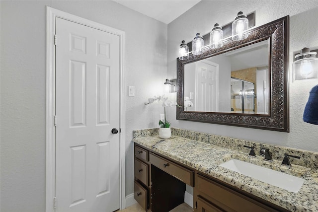 4636 Versailles Ln, Plano, TX 75093 - full bathroom with a textured wall, vanity, and a stall shower