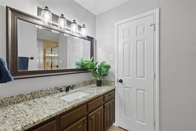 4636 Versailles Ln, Plano, TX 75093 - full bath featuring a stall shower, vanity, and a textured wall