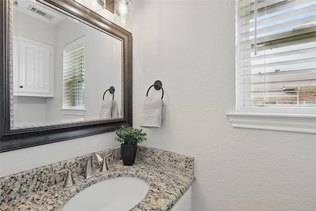 4636 Versailles Ln, Plano, TX 75093 - bathroom with a textured wall, plenty of natural light, and vanity