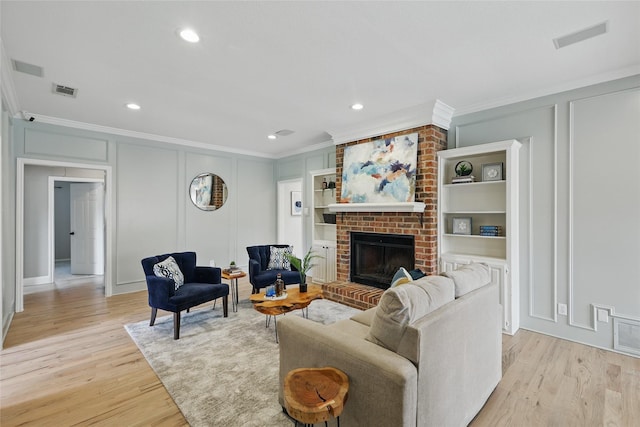 4636 Versailles Ln, Plano, TX 75093 - living area with ornamental molding, a decorative wall, light wood finished floors, a brick fireplace, and recessed lighting