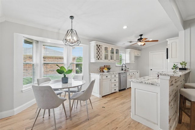 4636 Versailles Ln, Plano, TX 75093 - kitchen featuring ornamental molding, dishwasher, a peninsula, a sink, and plenty of natural light