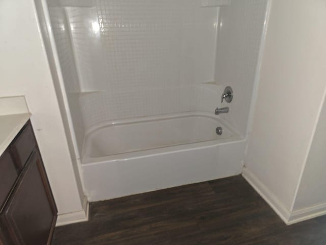 1322 Lucchese Ln, Dallas, TX 75253 - full bath with wood finished floors, vanity, shower / bathtub combination, and baseboards