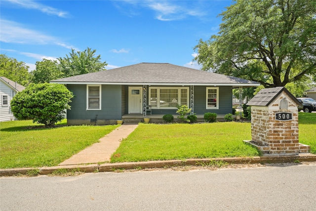 500 E Monterey St, Denison, TX 75021 - bungalow featuring a porch, a front yard, and roof with shingles