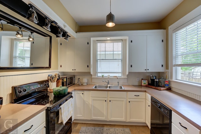 kitchen with black appliances, a sink, white cabinetry, light countertops, and light tile patterned floors