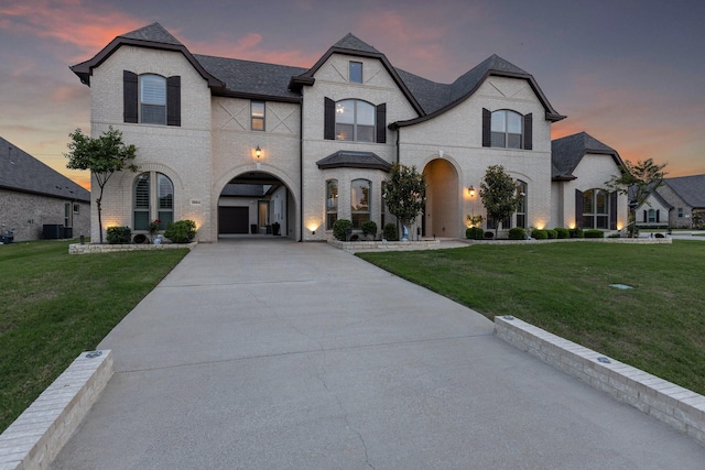 2604 Coyote Xing, Rockwall, TX 75087 - french country style house featuring brick siding, a yard, and driveway