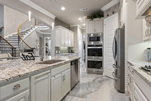 2604 Coyote Xing, Rockwall, TX 75087 - kitchen featuring a sink, appliances with stainless steel finishes, crown molding, white cabinetry, and light marble finish floors