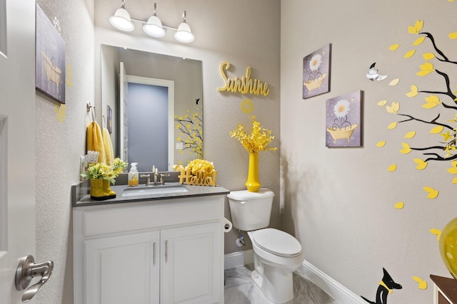 2604 Coyote Xing, Rockwall, TX 75087 - bathroom featuring vanity, toilet, and baseboards