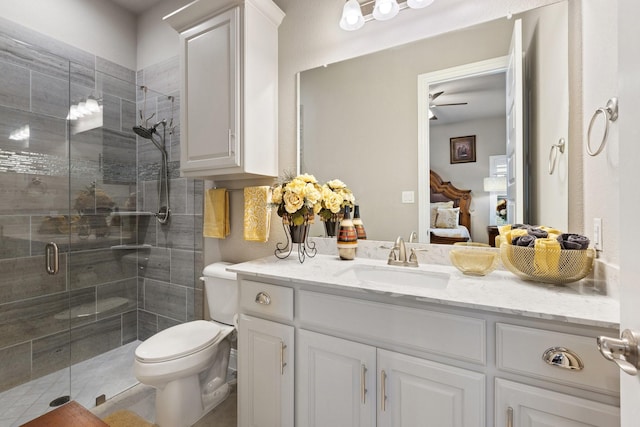 2604 Coyote Xing, Rockwall, TX 75087 - ensuite bathroom with vanity, a stall shower, ceiling fan, and toilet