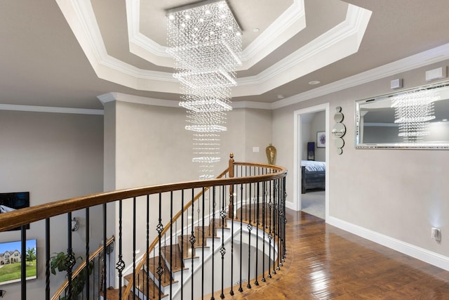 2604 Coyote Xing, Rockwall, TX 75087 - corridor featuring a chandelier, a raised ceiling, an upstairs landing, wood finished floors, and ornamental molding