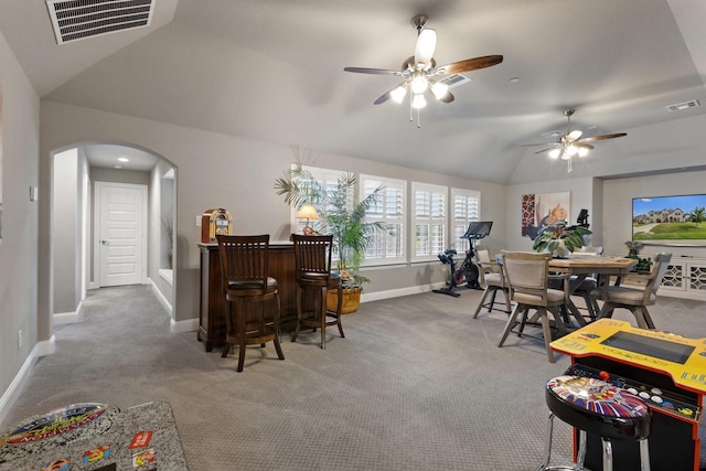2604 Coyote Xing, Rockwall, TX 75087 - carpeted dining space featuring vaulted ceiling, baseboards, arched walkways, and ceiling fan