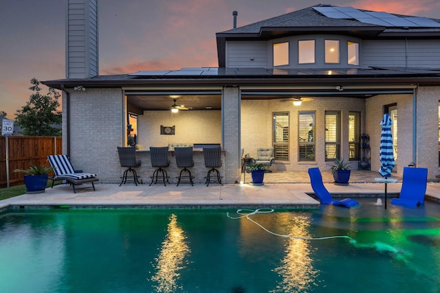 2604 Coyote Xing, Rockwall, TX 75087 - back of house featuring ceiling fan, a patio area, a chimney, solar panels, and brick siding
