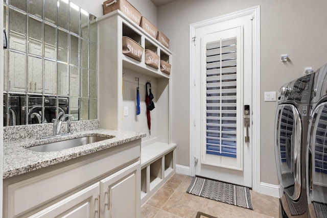 2604 Coyote Xing, Rockwall, TX 75087 - mudroom featuring separate washer and dryer, a sink, baseboards, and light tile patterned flooring