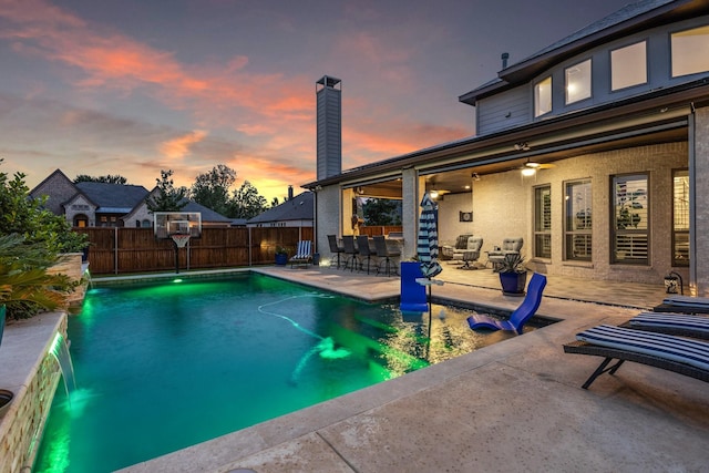 2604 Coyote Xing, Rockwall, TX 75087 - pool at dusk featuring a fenced backyard and a patio area