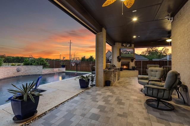 2604 Coyote Xing, Rockwall, TX 75087 - fenced backyard with an outdoor brick fireplace, ceiling fan, and a patio