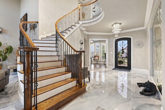 2604 Coyote Xing, Rockwall, TX 75087 - foyer entrance with marble tiled flooring, crown molding, stairs, a chandelier, and arched walkways