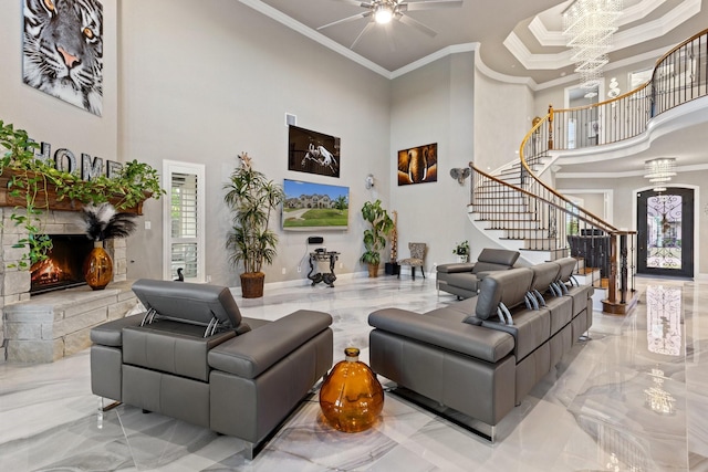 2604 Coyote Xing, Rockwall, TX 75087 - living room with marble tiled floors, a towering ceiling, stairs, ornamental molding, and a stone fireplace