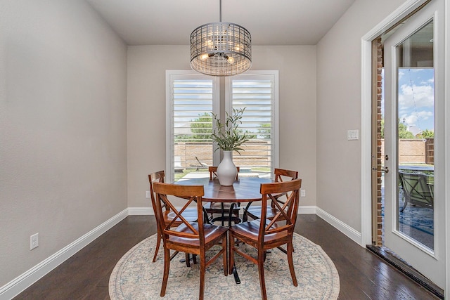 1607 Lilac Ln, Celina, TX 75009 - dining area with a chandelier, dark wood finished floors, and baseboards