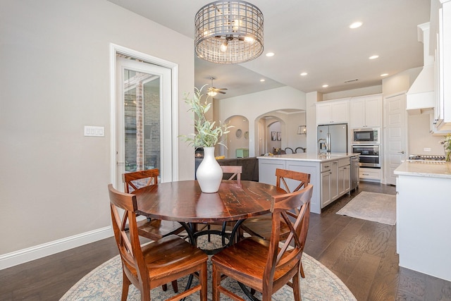 1607 Lilac Ln, Celina, TX 75009 - dining space with arched walkways, dark wood-style flooring, recessed lighting, baseboards, and a chandelier