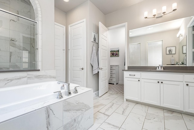 1607 Lilac Ln, Celina, TX 75009 - bathroom featuring a shower stall, a garden tub, marble look tile flooring, vanity, and baseboards