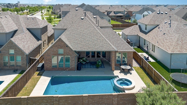 1607 Lilac Ln, Celina, TX 75009 - view of pool with a fenced backyard, a residential view, a pool with connected hot tub, and a patio area