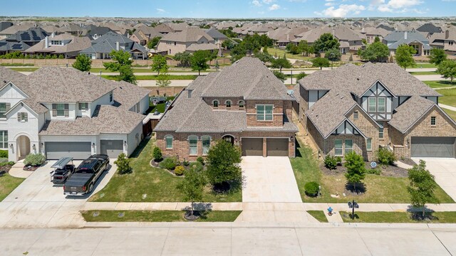 1607 Lilac Ln, Celina, TX 75009 - view of front facade featuring driveway, brick siding, a residential view, and a garage